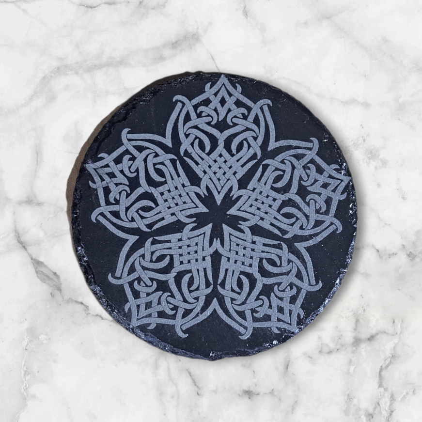 Slate coaster with intricate Celtic knot flower design engraved into it