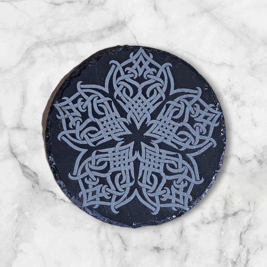 Slate coaster with intricate Celtic knot flower design engraved into it