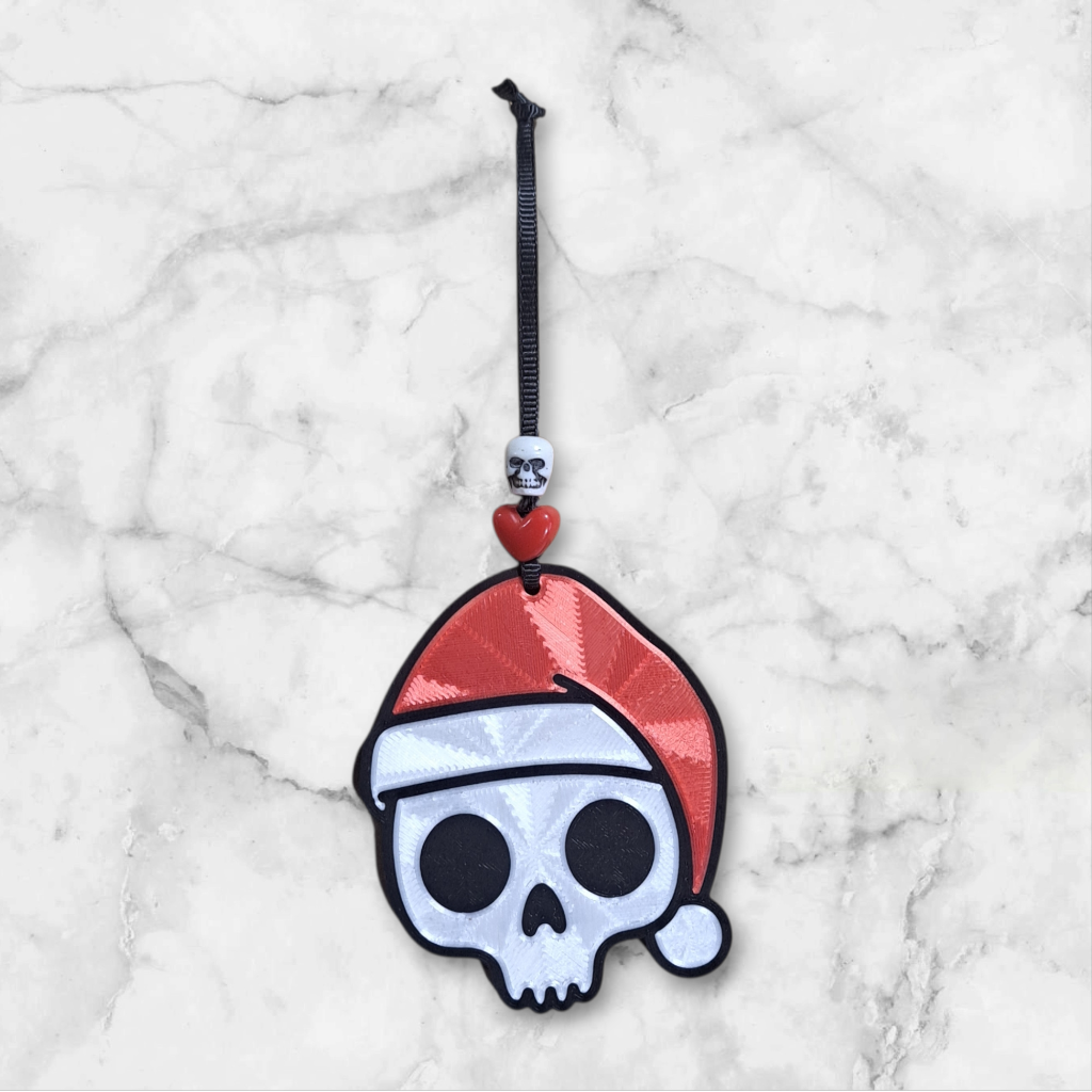 3d printed Skull-shaped ornament with a Santa hat, beaded with a heart and skull ribbon hanger