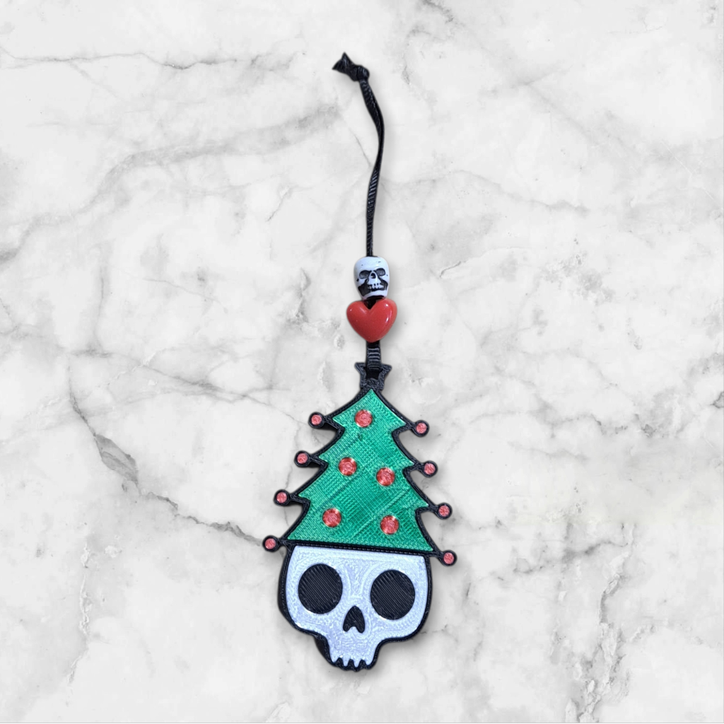 3d printed Skull with a Christmas tree hat ornament, beaded with a heart and skull ribbon hanger