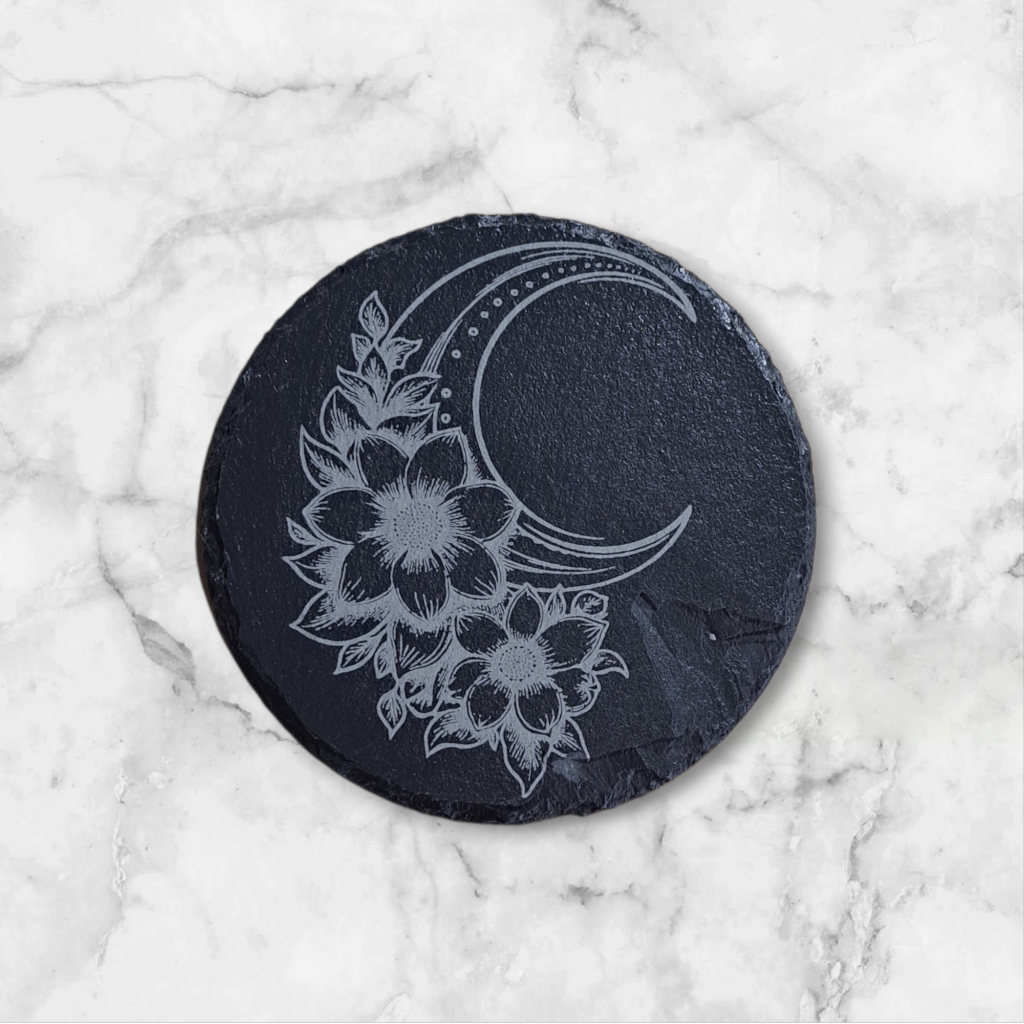 Round slate coaster with floral and moon design 